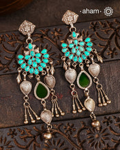Introducing our Ira Silver Earrings, featuring a stunning turquoise stone and a subtle green glass highlight handcrafted in 92.5 silver. Our modern design incorporates traditional techniques, resulting in a unique and elegant piece. Elevate your style with these beautiful earrings.