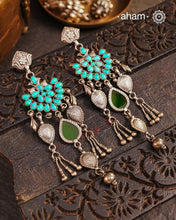 Introducing our Ira Silver Earrings, featuring a stunning turquoise stone and a subtle green glass highlight handcrafted in 92.5 silver. Our modern design incorporates traditional techniques, resulting in a unique and elegant piece. Elevate your style with these beautiful earrings.
