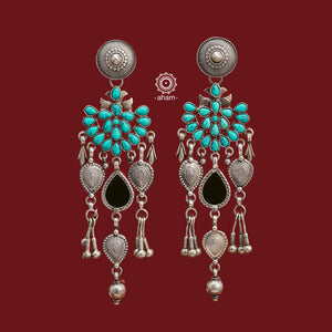 Introducing our Ira Silver Earrings, featuring a stunning turquoise stone and a subtle green glass highlight handcrafted in 92.5 silver. Our modern design incorporates traditional techniques, resulting in a unique and elegant piece. Elevate your style with these beautiful earrings.