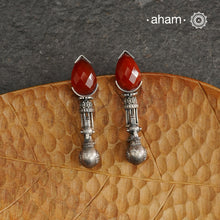 Enhance your style with these Ira Carnelian Peacock Silver Earrings. The stunning peacock design and vibrant carnelian stone create a unique and understated look. Handcrafted in 92.5 silver, these earrings are a perfect addition to any jewellery collection.