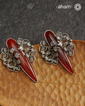 Elevate any look with our Ira Carnelian Stone Silver Earrings. These stunning statement earrings feature a carnelian drop with intricate silver filigree patterns, crafted in 92.5 silver. Perfect for formal events, these earrings add a touch of elegance and sophistication.