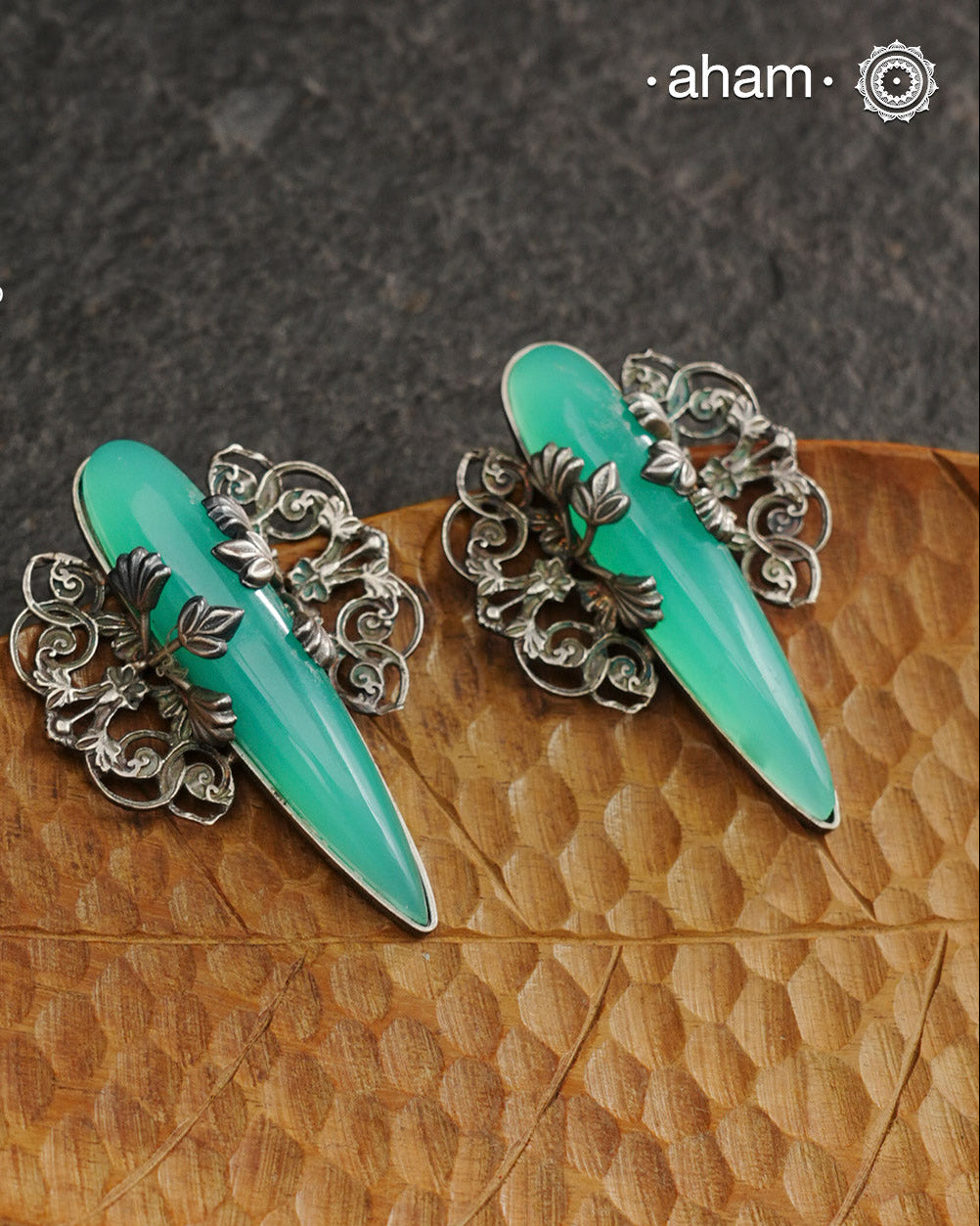 Elevate any look with our Ira Sea Green Stone Silver Earrings. These stunning statement earrings feature a sea green stone drop with intricate silver filigree patterns, crafted in 92.5 silver. Perfect for formal events, these earrings add a touch of elegance and sophistication.