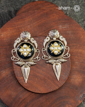 These Ira black onyx silver earrings feature stunning kundan inlay work and charming parrot motifs, making them a unique and eye-catching statement piece. Crafted with quality and attention to detail, these 92.5 silver earrings are sure to elevate any outfit. A must-have for any stylish and sophisticated wardrobe.