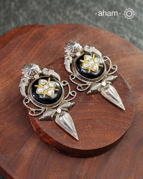 These Ira black onyx silver earrings feature stunning kundan inlay work and charming parrot motifs, making them a unique and eye-catching statement piece. Crafted with quality and attention to detail, these 92.5 silver earrings are sure to elevate any outfit. A must-have for any stylish and sophisticated wardrobe.
