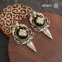 These Ira black onyx silver earrings feature stunning kundan inlay work and charming parrot motifs, making them a unique and eye-catching statement piece. Crafted with quality and attention to detail, these 92.5 silver earrings are sure to elevate any outfit. A must-have for any stylish and sophisticated wardrobe.