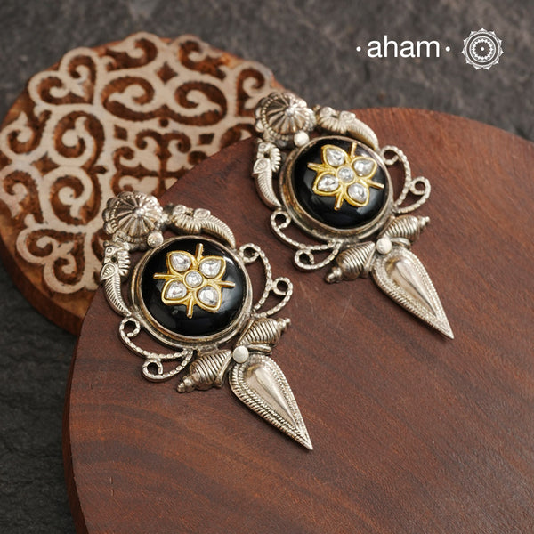 These Ira black onyx silver earrings feature stunning kundan inlay work and charming parrot motifs, making them a unique and eye-catching statement piece. Crafted with quality and attention to detail, these 92.5 silver earrings are sure to elevate any outfit. A must-have for any stylish and sophisticated wardrobe.
