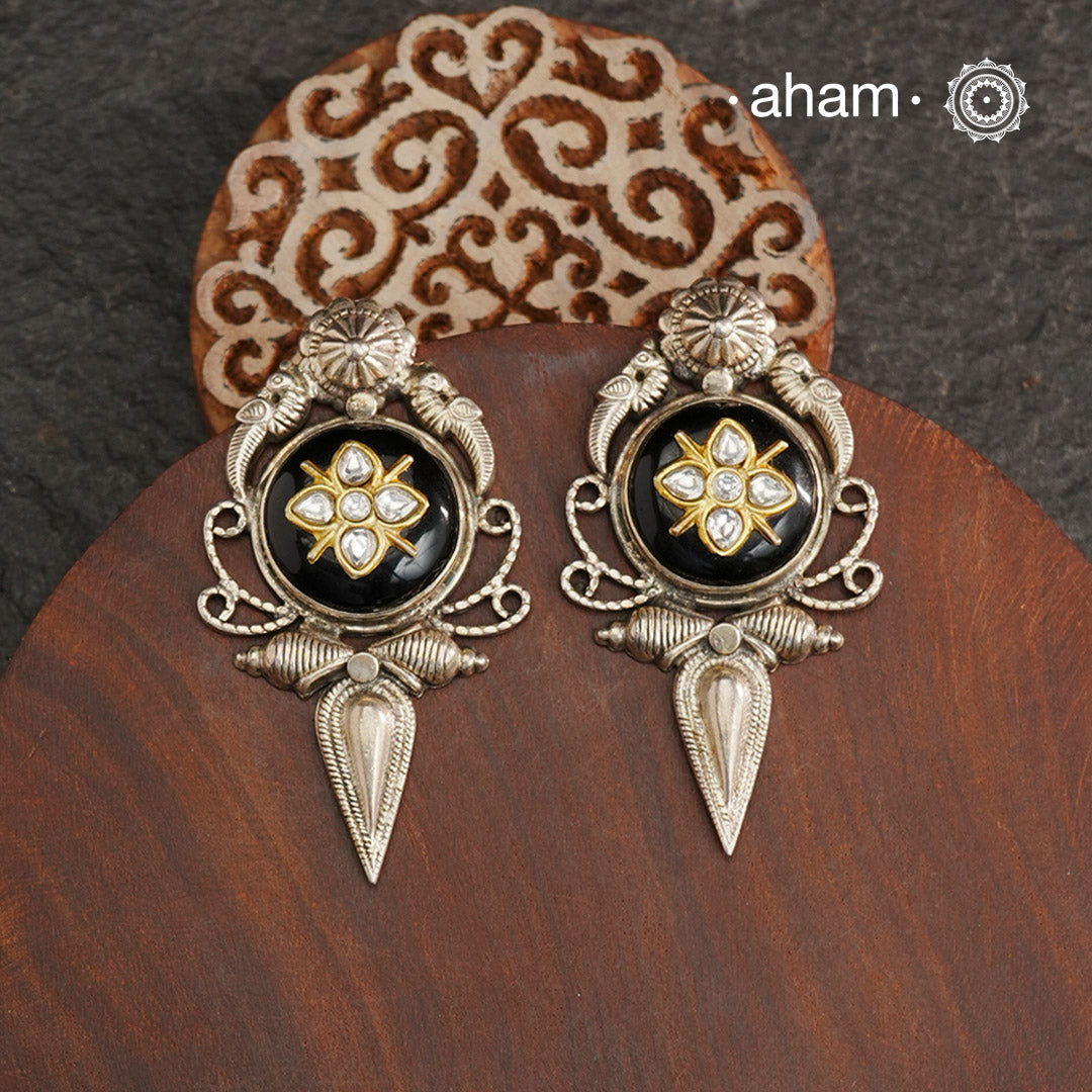 These Ira black onyx silver earrings feature stunning kundan inlay work and charming parrot motifs, making them a unique and eye-catching statement piece. Crafted with quality and attention to detail, these 92.5 silver earrings are sure to elevate any outfit. A must-have for any stylish and sophisticated wardrobe.