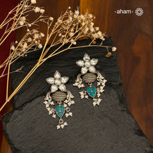 Elevate your style with our Ira Silver Earrings. Adorned with a stunning Kundan flower and turquoise drop, they add a touch of sparkle to any occasion. Made with 92.5 silver, these earrings are the perfect mix of elegance and charm. Shop now and make a statement.