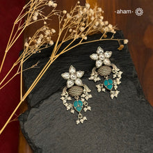 Elevate your style with our Ira Silver Earrings. Adorned with a stunning Kundan flower and turquoise drop, they add a touch of sparkle to any occasion. Made with 92.5 silver, these earrings are the perfect mix of elegance and charm. Shop now and make a statement.