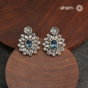 These Ira Silver Earrings add a touch of glamour to any outfit. With a stunning blue center stone and intricate zircon setting, these drop earrings are crafted in 92.5 silver for a luxurious touch. Elevate your style and make a statement with these elegant and timeless earrings.