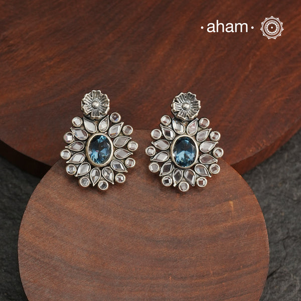 These Ira Silver Earrings add a touch of glamour to any outfit. With a stunning blue center stone and intricate zircon setting, these drop earrings are crafted in 92.5 silver for a luxurious touch. Elevate your style and make a statement with these elegant and timeless earrings.