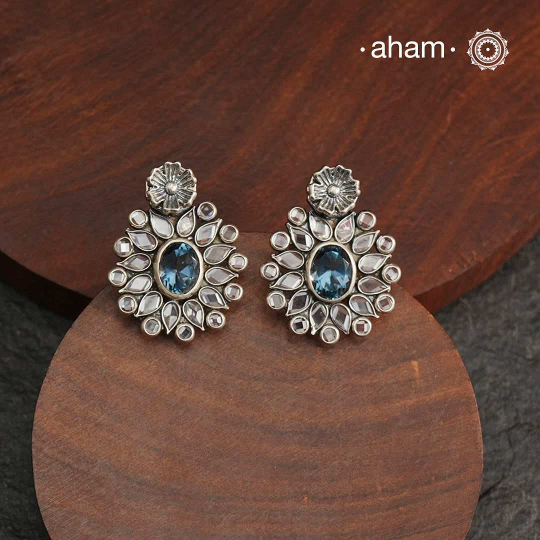 These Ira Silver Earrings add a touch of glamour to any outfit. With a stunning blue center stone and intricate zircon setting, these drop earrings are crafted in 92.5 silver for a luxurious touch. Elevate your style and make a statement with these elegant and timeless earrings.