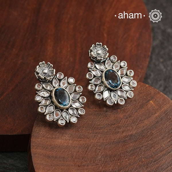 These Ira Silver Earrings add a touch of glamour to any outfit. With a stunning blue center stone and intricate zircon setting, these drop earrings are crafted in 92.5 silver for a luxurious touch. Elevate your style and make a statement with these elegant and timeless earrings.