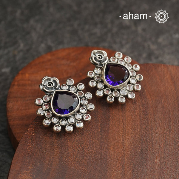 These Ira Silver Earrings add a touch of glamour to any outfit. With a stunning purple center stone and intricate zircon setting, these drop earrings are crafted in 92.5 silver for a luxurious touch. Elevate your style and make a statement with these elegant and timeless earrings.