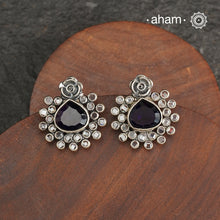 These Ira Silver Earrings add a touch of glamour to any outfit. With a stunning purple center stone and intricate zircon setting, these drop earrings are crafted in 92.5 silver for a luxurious touch. Elevate your style and make a statement with these elegant and timeless earrings.