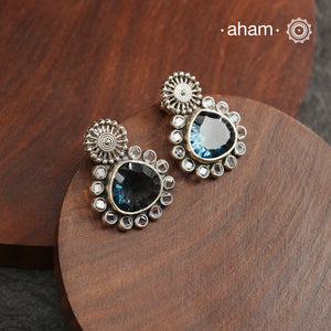 These Ira Silver Earrings add a touch of glamour to any outfit. With a stunning marine blue center stone and intricate zircon setting, these drop earrings are crafted in 92.5 silver for a luxurious touch. Elevate your style and make a statement with these elegant and timeless earrings.