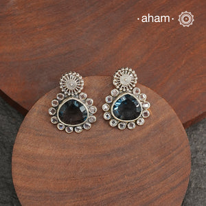 These Ira Silver Earrings add a touch of glamour to any outfit. With a stunning marine blue center stone and intricate zircon setting, these drop earrings are crafted in 92.5 silver for a luxurious touch. Elevate your style and make a statement with these elegant and timeless earrings.
