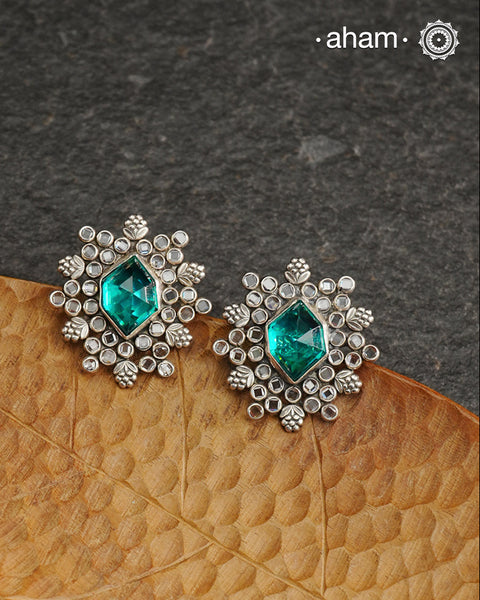 These Ira Silver Earrings add a touch of glamour to any outfit. With a stunning green center stone and intricate zircon setting, these drop earrings are crafted in 92.5 silver for a luxurious touch. Elevate your style and make a statement with these elegant and timeless earrings.