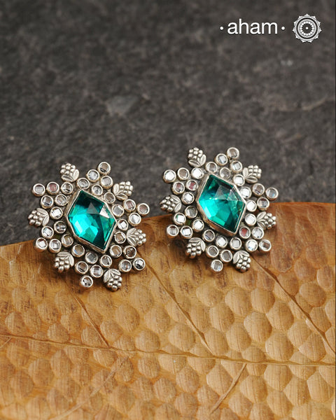 These Ira Silver Earrings add a touch of glamour to any outfit. With a stunning green center stone and intricate zircon setting, these drop earrings are crafted in 92.5 silver for a luxurious touch. Elevate your style and make a statement with these elegant and timeless earrings.