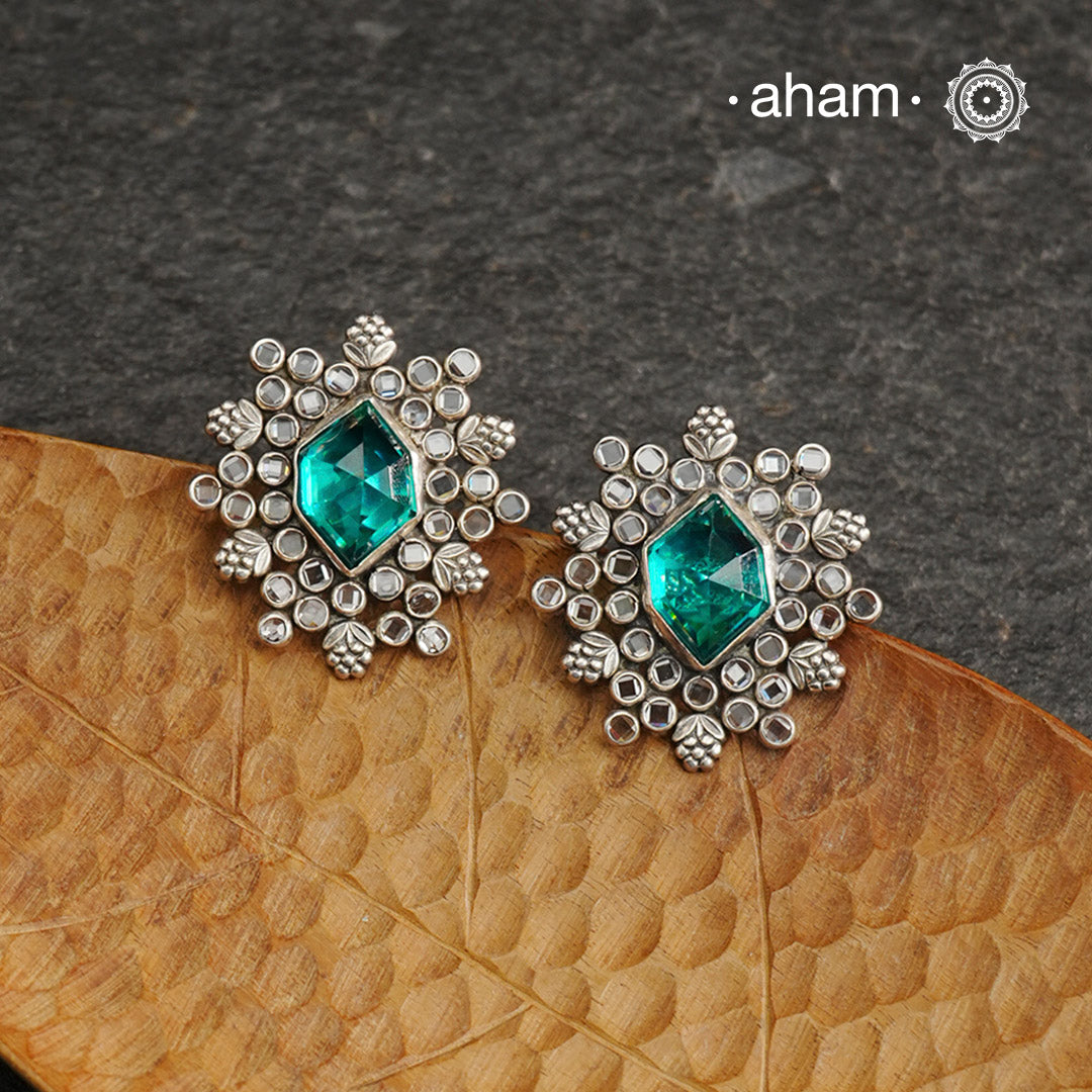 These Ira Silver Earrings add a touch of glamour to any outfit. With a stunning green center stone and intricate zircon setting, these drop earrings are crafted in 92.5 silver for a luxurious touch. Elevate your style and make a statement with these elegant and timeless earrings.