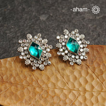 These Ira Silver Earrings add a touch of glamour to any outfit. With a stunning green center stone and intricate zircon setting, these drop earrings are crafted in 92.5 silver for a luxurious touch. Elevate your style and make a statement with these elegant and timeless earrings.