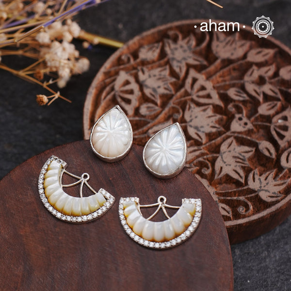 Upgrade your earring game with our Handcarved Natural Mother of Pearl Silver Studs. These stunning 925 silver studs feature handcarved mother of pearl, adding a touch of elegance to any outfit. The detachable top makes them versatile, giving you two different looks in one. Elevate your style with these unique and beautiful studs.