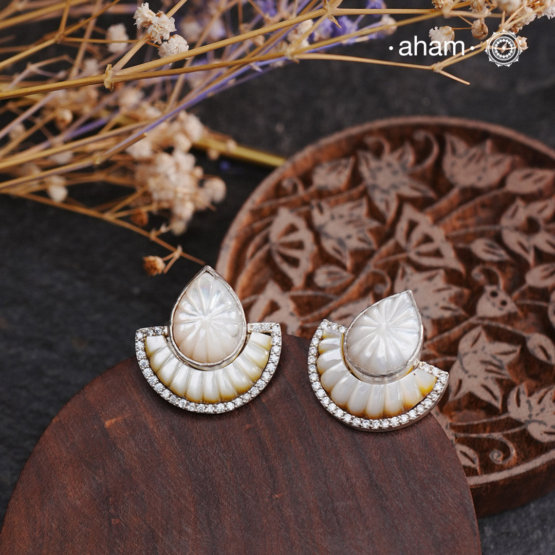 Upgrade your earring game with our Handcarved Natural Mother of Pearl Silver Studs. These stunning 925 silver studs feature handcarved mother of pearl, adding a touch of elegance to any outfit. The detachable top makes them versatile, giving you two different looks in one. Elevate your style with these unique and beautiful studs.