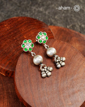 The Ira Silver Earrings are the perfect accent for your wardrobe. Crafted in silver with green kundan highlight on the top
