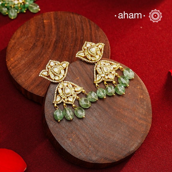 Expertly crafted earrings in 92.5% sterling silver with a refined gold polish finish and elegantly set with brilliant moissanite stones and green drops. Designed to offer lasting shine and sophistication making them a perfect choice for special occasions.
