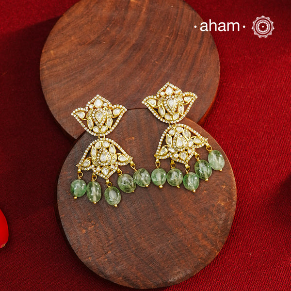 Expertly crafted earrings in 92.5% sterling silver with a refined gold polish finish and elegantly set with brilliant moissanite stones and green drops. Designed to offer lasting shine and sophistication making them a perfect choice for special occasions.
