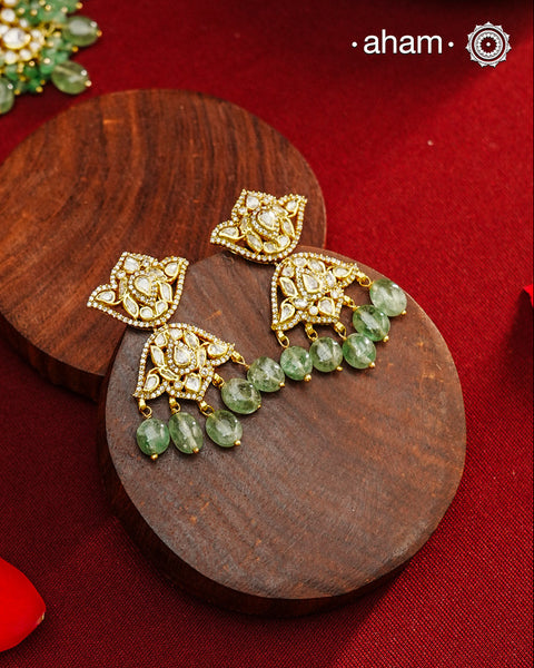 Expertly crafted earrings in 92.5% sterling silver with a refined gold polish finish and elegantly set with brilliant moissanite stones and green drops. Designed to offer lasting shine and sophistication making them a perfect choice for special occasions.