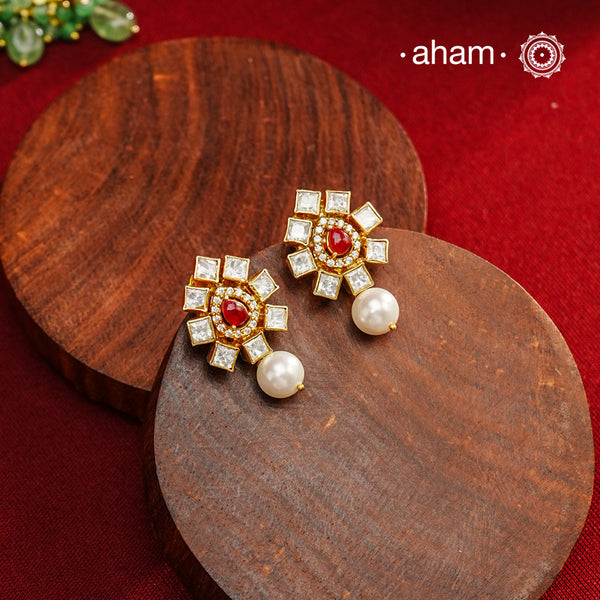 Expertly crafted earrings in 92.5% sterling silver with a refined gold polish finish and elegantly set with brilliant moissanite stones, red stone center and a pearl drop. Designed to offer lasting shine and sophistication making them a perfect choice for special occasions.
