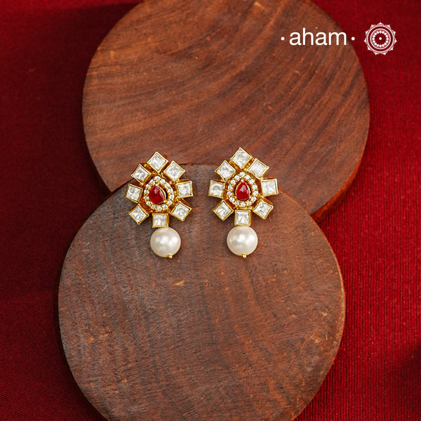 Expertly crafted earrings in 92.5% sterling silver with a refined gold polish finish and elegantly set with brilliant moissanite stones, red stone center and a pearl drop. Designed to offer lasting shine and sophistication making them a perfect choice for special occasions.