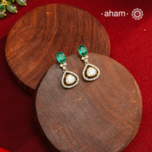 These expertly crafted earrings feature 92.5% sterling silver with a fine gold polish finish, elegantly set with brilliant moissanite stones and a lustrous green stone on the center. Designed to offer lasting shine and sophistication making them a perfect choice for both everyday wear and special occasions.