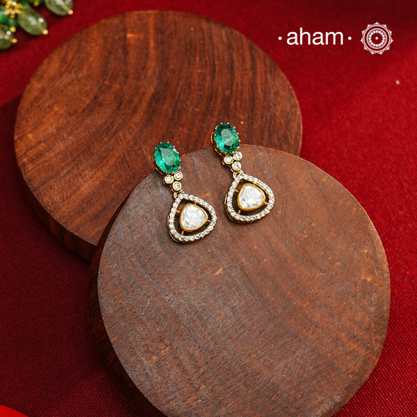 These expertly crafted earrings feature 92.5% sterling silver with a fine gold polish finish, elegantly set with brilliant moissanite stones and a lustrous green stone on the center. Designed to offer lasting shine and sophistication making them a perfect choice for both everyday wear and special occasions.