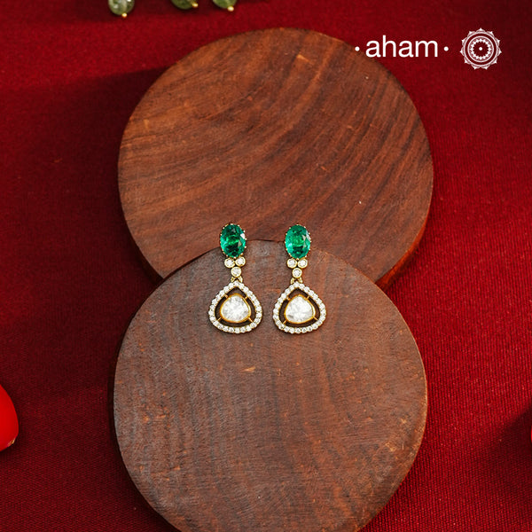 These expertly crafted earrings feature 92.5% sterling silver with a fine gold polish finish, elegantly set with brilliant moissanite stones and a lustrous green stone on the center. Designed to offer lasting shine and sophistication making them a perfect choice for both everyday wear and special occasions.