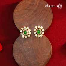 These expertly crafted studs feature 92.5% sterling silver with a fine gold polish finish, elegantly set with brilliant moissanite stones and a lustrous green stone in the center. Designed to offer lasting shine and sophistication making them a perfect choice for both everyday wear and special occasions.  