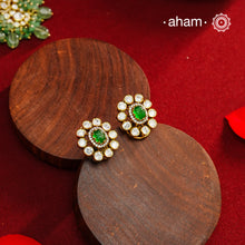 These expertly crafted studs feature 92.5% sterling silver with a fine gold polish finish, elegantly set with brilliant moissanite stones and a lustrous green stone in the center. Designed to offer lasting shine and sophistication making them a perfect choice for both everyday wear and special occasions.  
