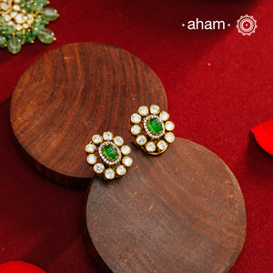 These expertly crafted studs feature 92.5% sterling silver with a fine gold polish finish, elegantly set with brilliant moissanite stones and a lustrous green stone in the center. Designed to offer lasting shine and sophistication making them a perfect choice for both everyday wear and special occasions.  