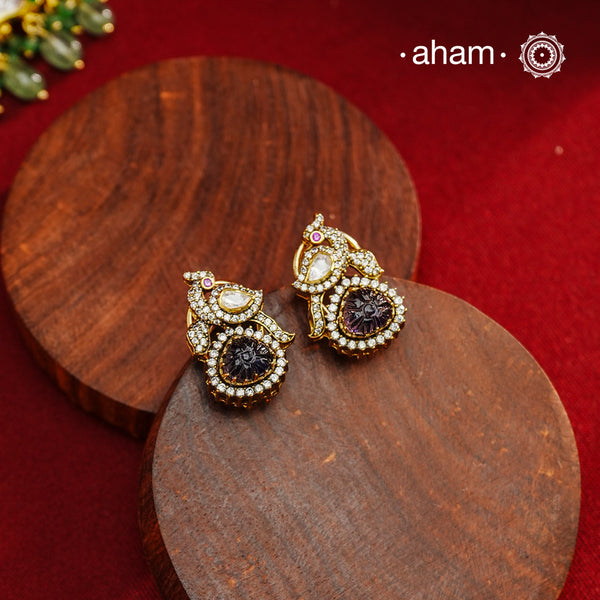 These expertly crafted studs feature 92.5% sterling silver with a fine gold polish finish, elegantly set with brilliant moissanite stones and a lustrous deep purple stone drop. Designed to offer lasting shine and sophistication making them a perfect choice for both everyday wear and special occasions.  