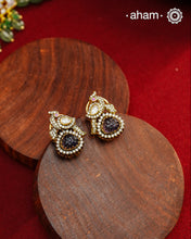 These expertly crafted studs feature 92.5% sterling silver with a fine gold polish finish, elegantly set with brilliant moissanite stones and a lustrous deep purple stone drop. Designed to offer lasting shine and sophistication making them a perfect choice for both everyday wear and special occasions. 