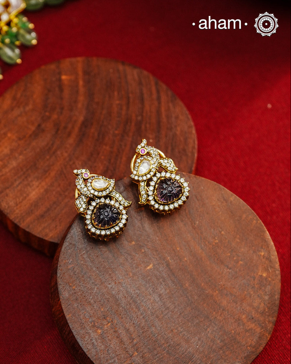 These expertly crafted studs feature 92.5% sterling silver with a fine gold polish finish, elegantly set with brilliant moissanite stones and a lustrous deep purple stone drop. Designed to offer lasting shine and sophistication making them a perfect choice for both everyday wear and special occasions. 