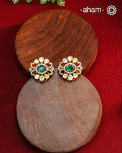 These expertly crafted studs feature 92.5% sterling silver with a fine gold polish finish, elegantly set with brilliant moissanite stones and a lustrous green stone in the center. Designed to offer lasting shine and sophistication making them a perfect choice for both everyday wear and special occasions.