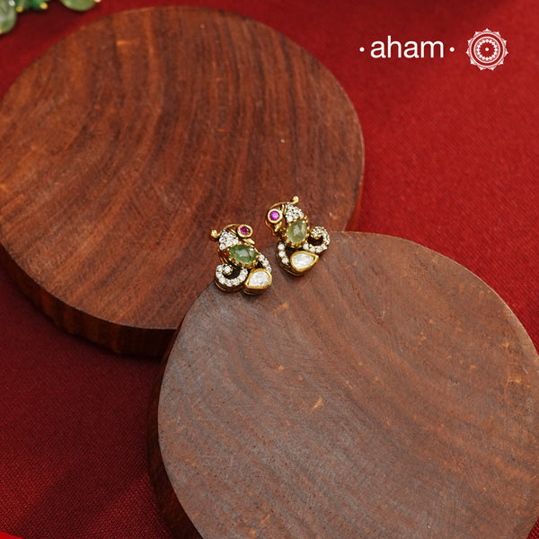 These expertly crafted studs feature 92.5% sterling silver with a fine gold polish finish, elegantly set with brilliant moissanite stones and a lustrous green stone in the center. Designed to offer lasting shine and sophistication making them a perfect choice for both everyday wear and special occasions.  