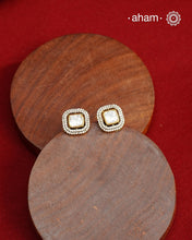 These expertly crafted studs feature 92.5% sterling silver with a fine gold polish finish, elegantly set with brilliant moissanite stones and a lustrous green stone in the center. Designed to offer lasting shine and sophistication making them a perfect choice for both everyday wear and special occasions.