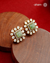 Expertly crafted studs in 92.5% sterling silver with a fine gold polish finish, elegantly set with brilliant moissanite stones and a lustrous green stone in the center. Designed to offer lasting shine and sophistication making them a perfect choice for special occasions.