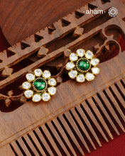 These expertly crafted studs feature 92.5% sterling silver with a fine gold polish finish, elegantly set with brilliant moissanite stones and a lustrous green stone in the center. Designed to offer lasting shine and sophistication making them a perfect choice for both everyday wear and special occasions.