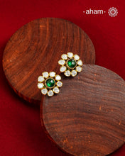 These expertly crafted studs feature 92.5% sterling silver with a fine gold polish finish, elegantly set with brilliant moissanite stones and a lustrous green stone in the center. Designed to offer lasting shine and sophistication making them a perfect choice for both everyday wear and special occasions.