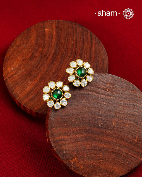 These expertly crafted studs feature 92.5% sterling silver with a fine gold polish finish, elegantly set with brilliant moissanite stones and a lustrous green stone in the center. Designed to offer lasting shine and sophistication making them a perfect choice for both everyday wear and special occasions.
