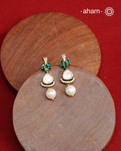 Expertly crafted studs in 92.5% sterling silver with a fine gold polish finish and elegantly set with brilliant moissanite stones and lustrous green stones. Designed to offer lasting shine and sophistication making them a perfect choice for special occasions.